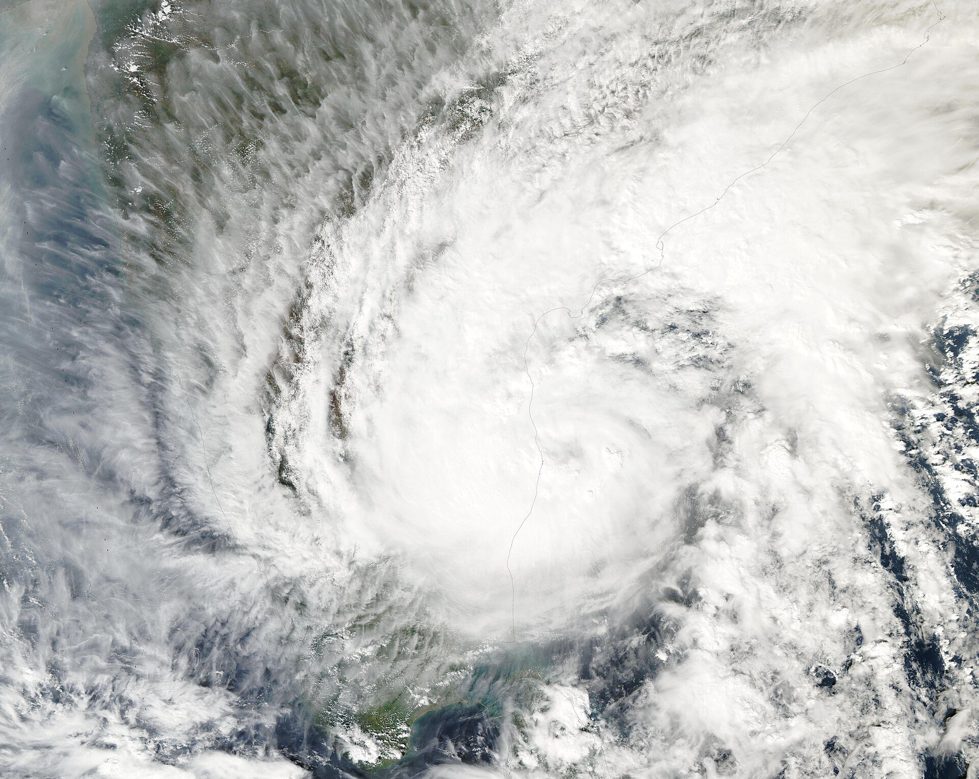 Satellite image of a large white swirl of cloud from a tropical cyclone over the Bay of Bengal, with the east coast of India visible beneath it.
