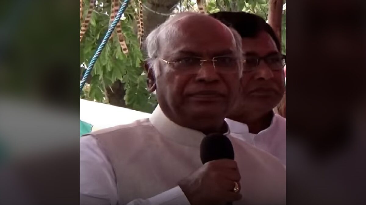 Mallikarjun Kharge speaking into a microphone