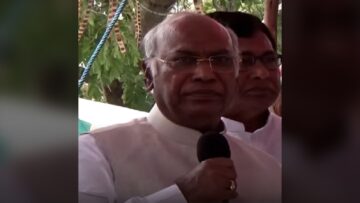 Mallikarjun Kharge speaking into a microphone