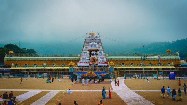 Pilgrims in the open courtyard in front of the main gopuram of the Sri Venkateswara temple at Tirumala.