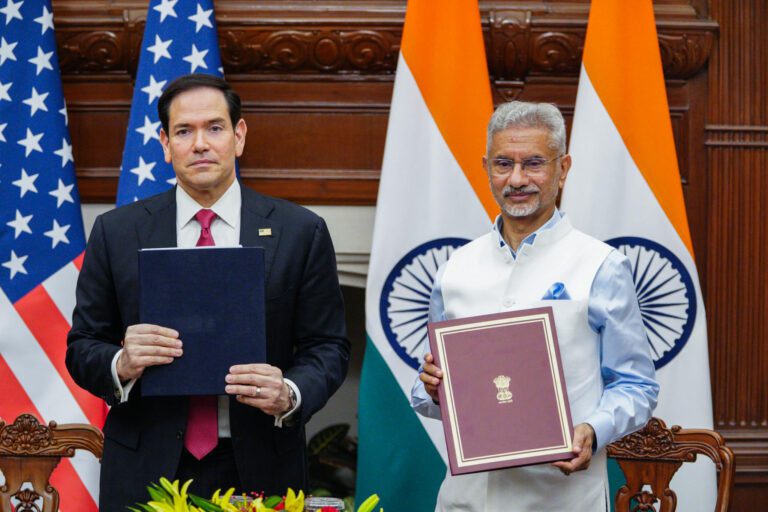 US Secretary of State Marco Rubio and External Affairs Minister S Jaishankar hold document folders in front of US and Indian flags