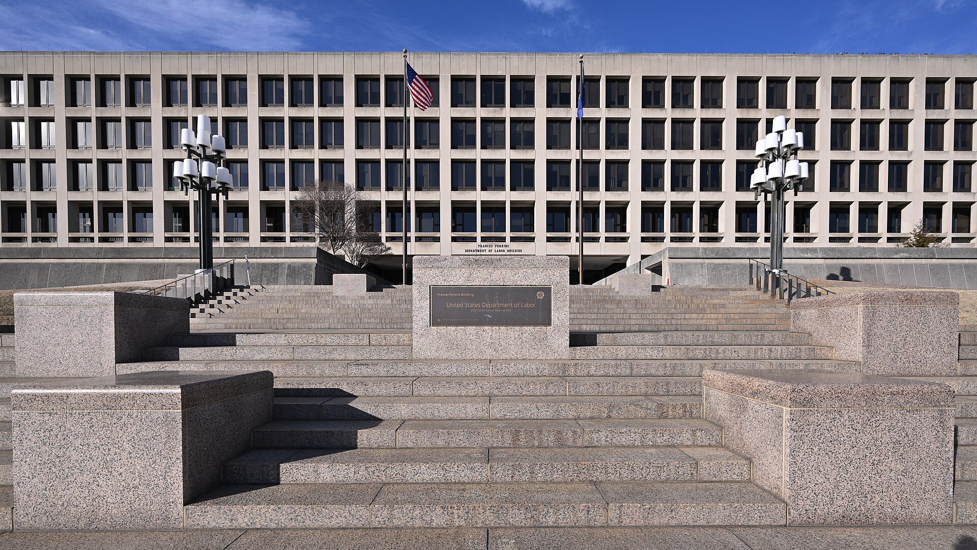 The Frances Perkins Building, headquarters of the US Department of Labor in Washington, DC, with flags and granite steps in front