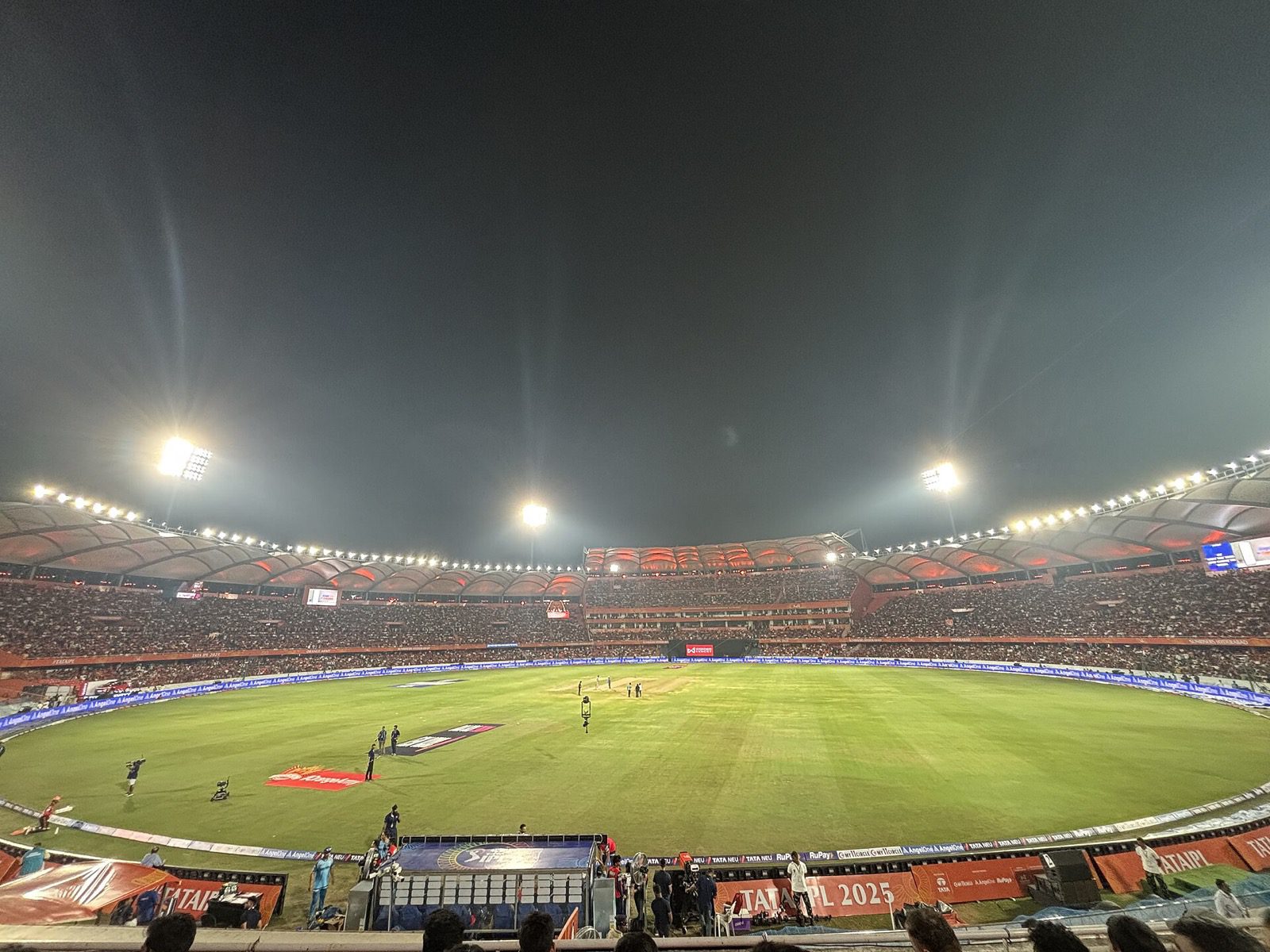 A packed, floodlit cricket stadium in Hyderabad during a night match.