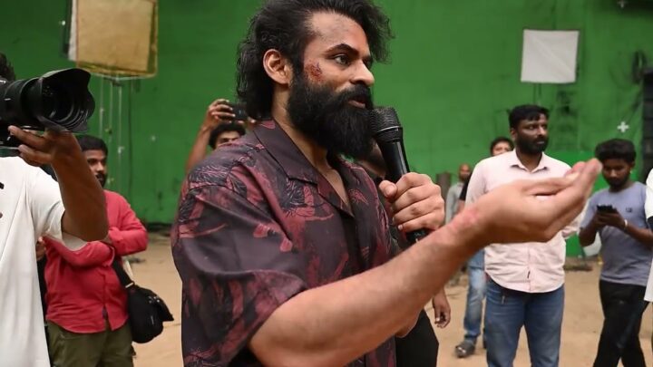 Sai Durgha Tej speaks into a microphone on the Sambarala Yeti Gattu set as the film wraps, with crew members around him.