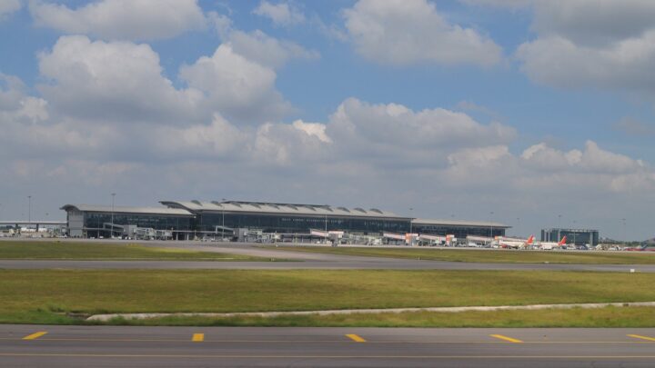 The terminal building of Rajiv Gandhi International Airport seen across the airfield, with aircraft parked at the gates.